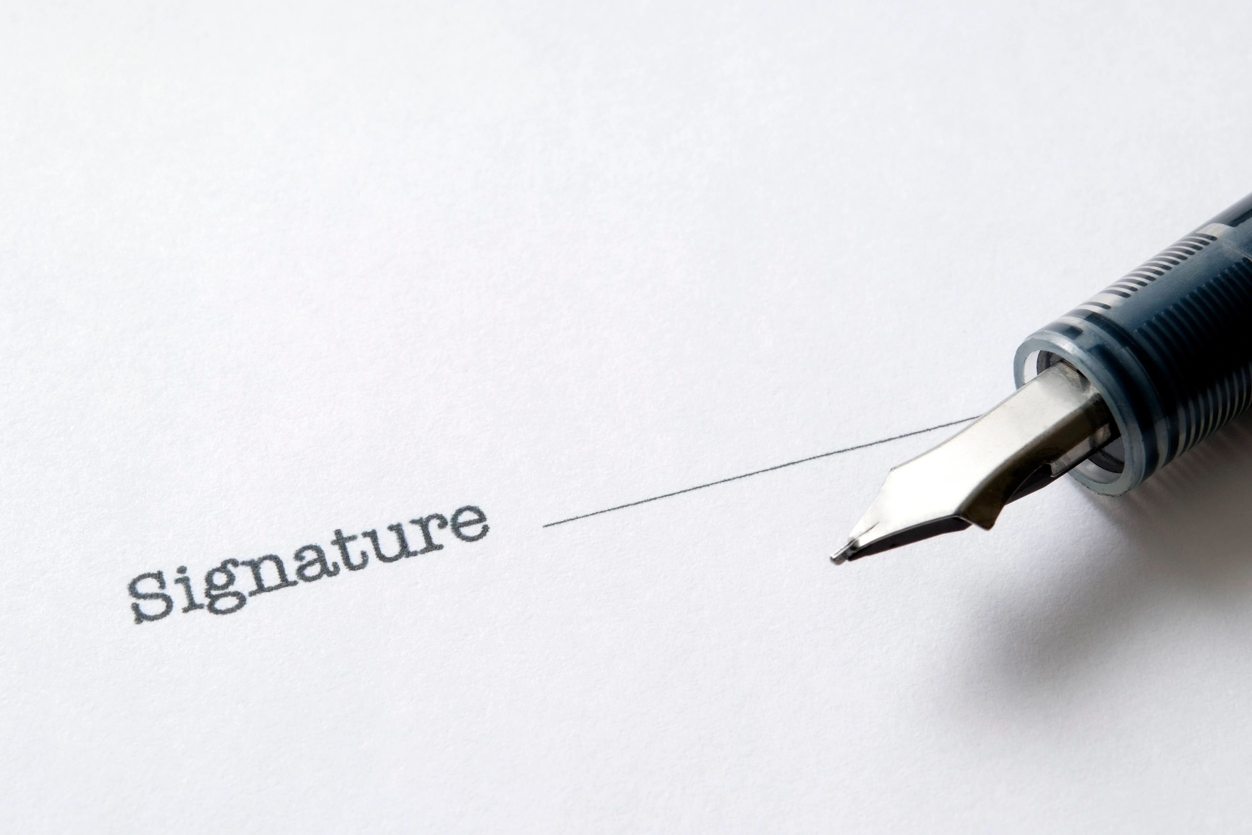 Close-up of a contract document with a pen