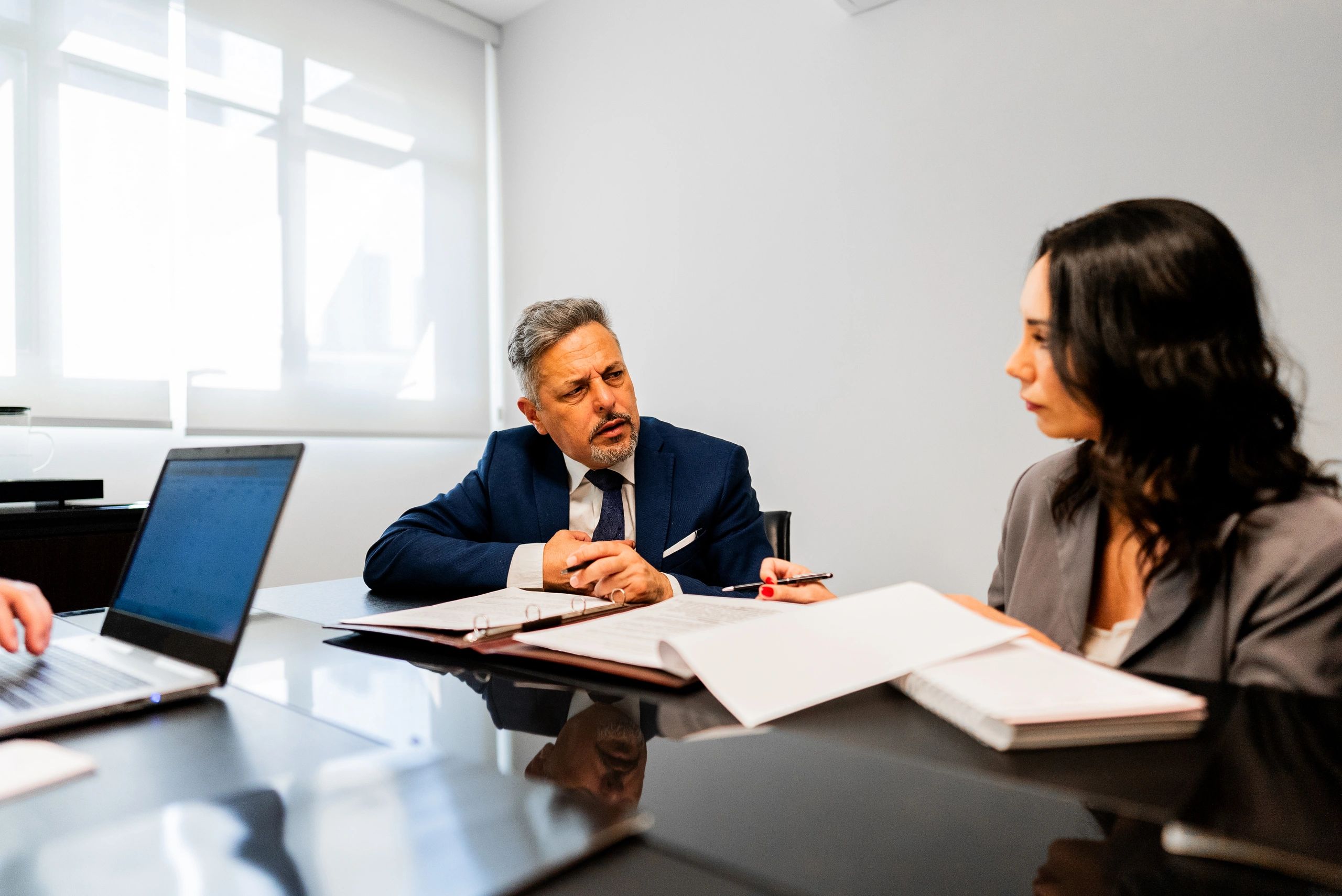 Colleagues speaking in a professional office setting
