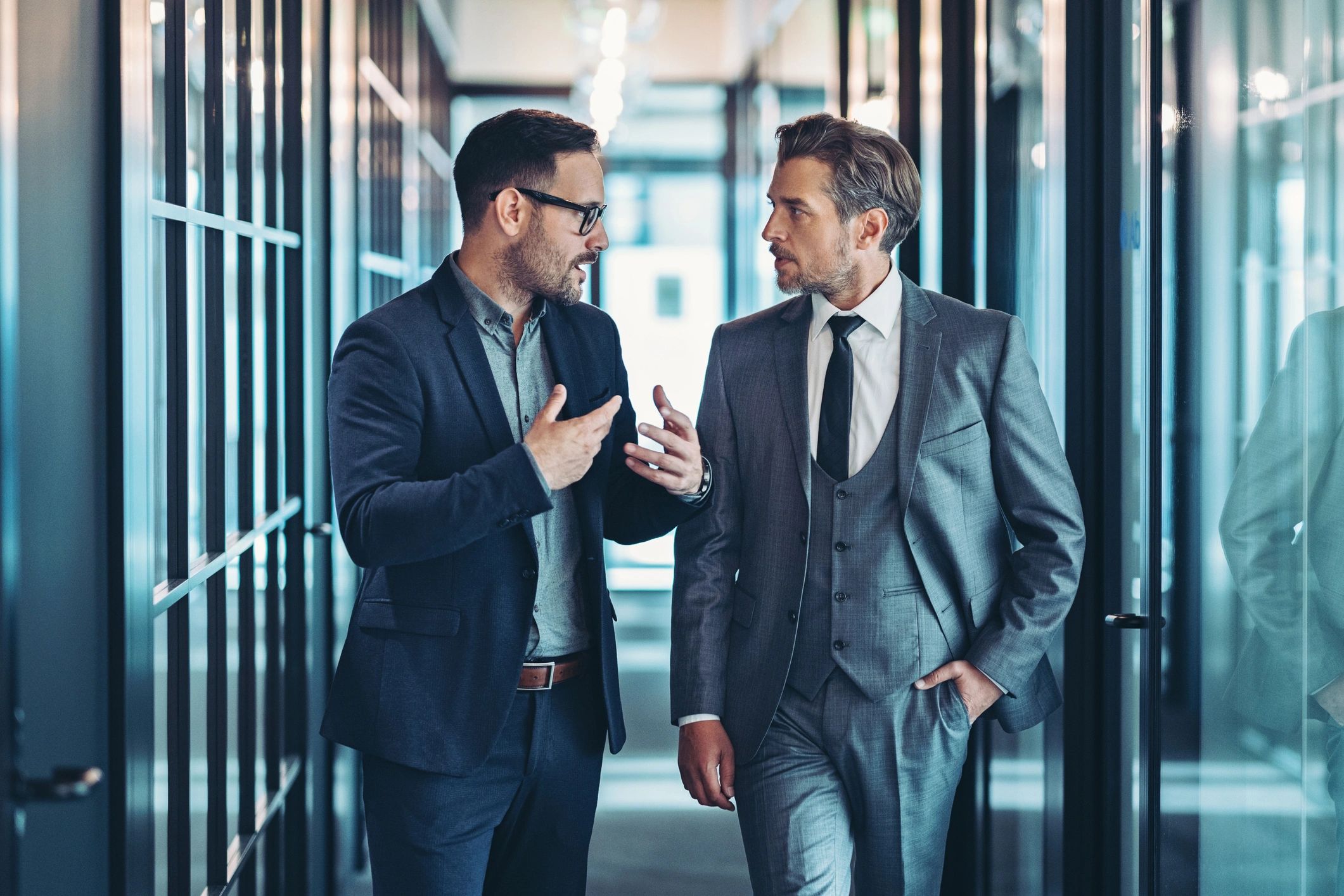 Professionals discussing a case in an office corridor