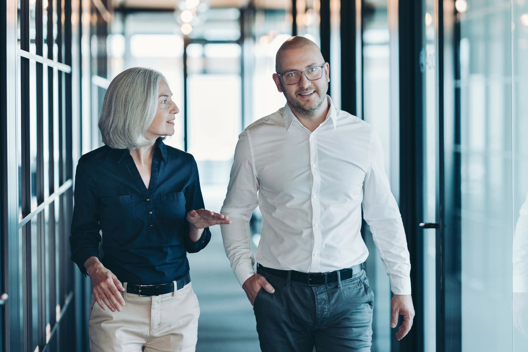 Legal professionals walking and discussing a client matter